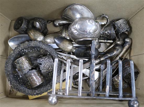 A silver toast rack, ten Hanau white metal tot holders and a similar cream jug and assorted mixed cutlery including silver.